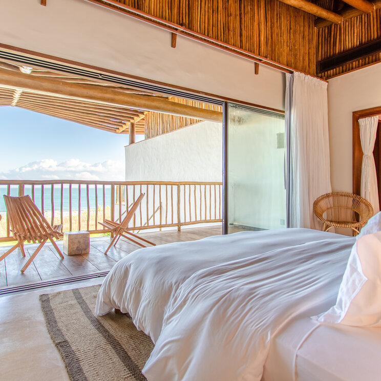 Master Suite im Hotel Villa Mandi in Jericoacoara, Brasilien, mit modernem Design und Zugang zum Badezimmer.